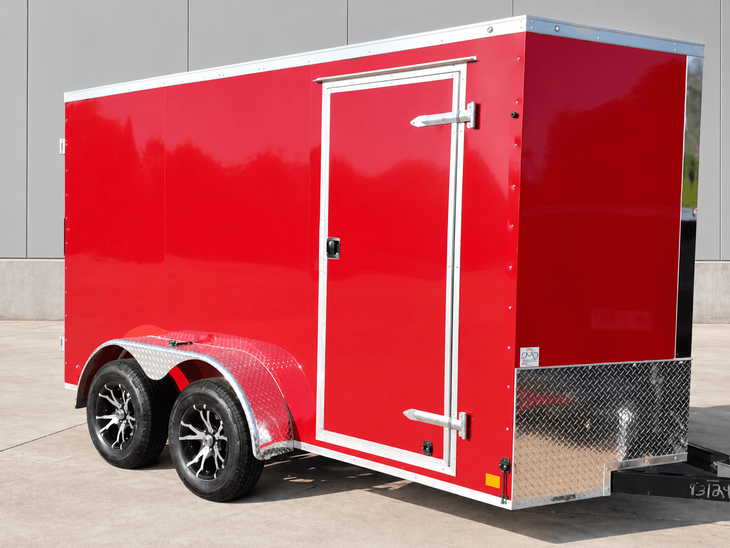 Red DE Series enclosed cargo trailer on a tandem axle with a side entry door